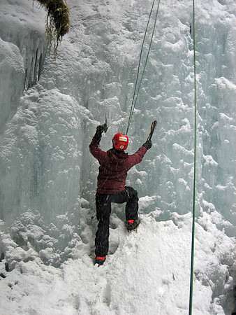 Kathleen ice climbing a frozen waterfall in the backyard